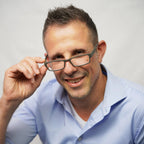 Klammeraffe No.01 reading glasses in mud color with longer temples, worn by a man on a white background.