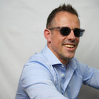 Klammeraffe No.11 bifocal reading sunglasses in cloud color with longer temples, worn by a man on a white background.