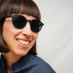 Klammeraffe No.12 bifocal reading sunglasses in black color with longer temples, worn by a woman on a white background.