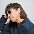 Klammeraffe No.12 bifocal reading sunglasses in crystal color with longer temples, worn by a woman on a white background.